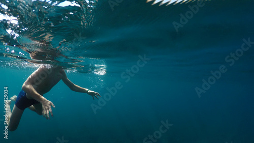 young man swims into the sea