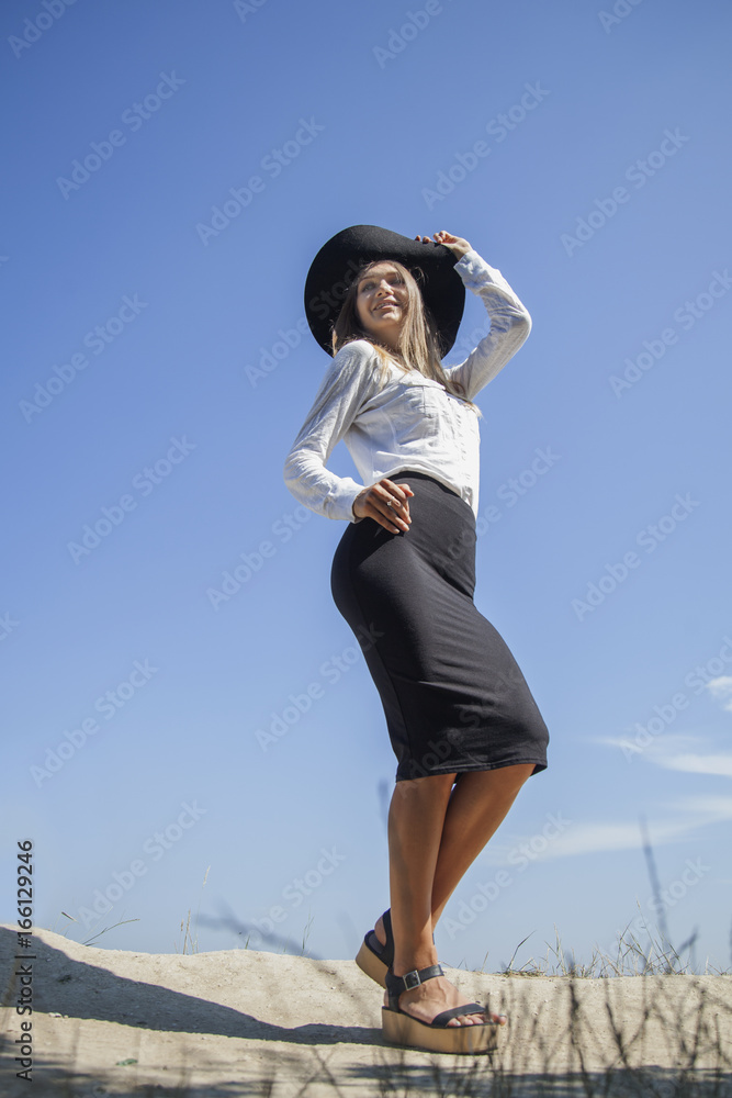 Portrait of beautiful young happy woman on holiday against blue background of sky. (Vacation, summer, sea concept) Portrait of beautiful young happy woman on holiday against blue background of sky. (Vacation, summer, sea concept)