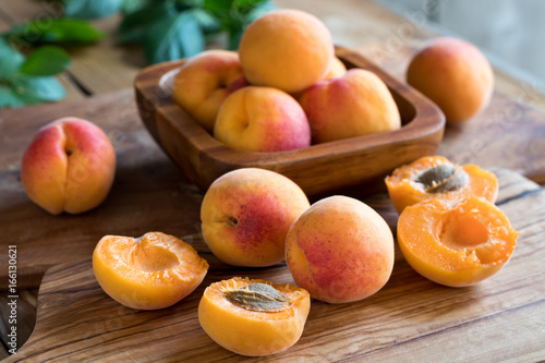 Freshly harvested apricots on a wooden background