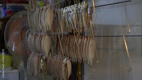 4K Fish hanging to dry on a line in Gukje International Market in Busan city. Korean vendors selling food in the street, South Korea-Dan photo