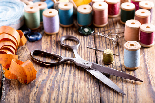 sewing tools : scissors, bobbins with thread and needles