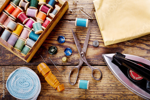 sewing tools : scissors, bobbins with thread and iron