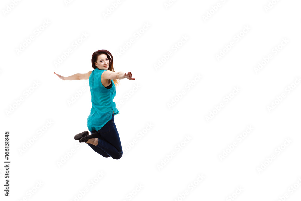 Young woman jumping on white background