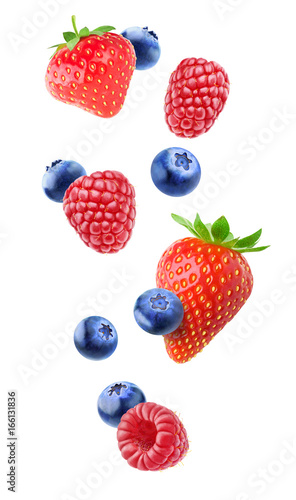 Isolated berries in the air. Falling strawberry, raspberry and blueberry fruits isolated on white background with clipping path