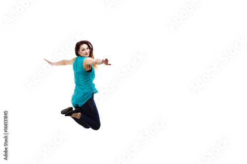 Young woman jumping on white background