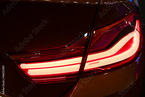 Red Rear light on a modern red car with reflection. The Closeup Back Red Tail light car