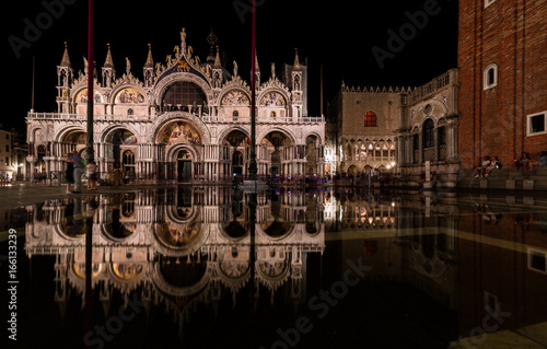 San Marco's Basilica Venice Italy with aqua alta (high tide) in the night photo