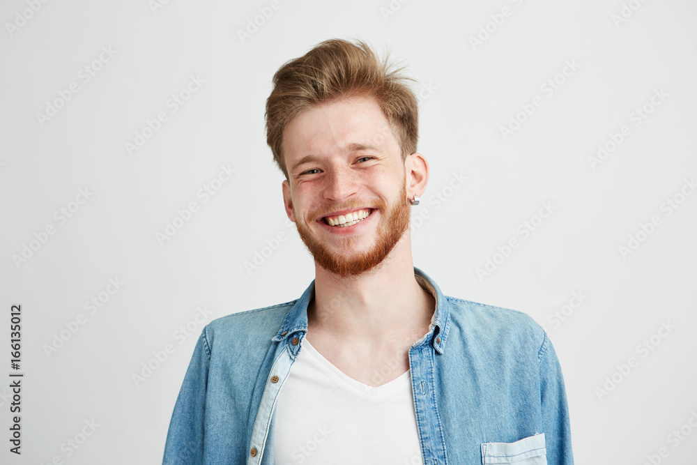 Portrait of young handsome hipster man with beard smiling laughing looking at camera over white background. Portrait of young handsome hipster man with beard smiling laughing looking at camera over white background.