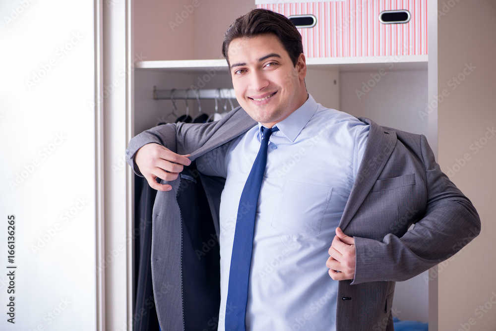 Young man businessman getting dressed for work Young man businessman getting dressed for work