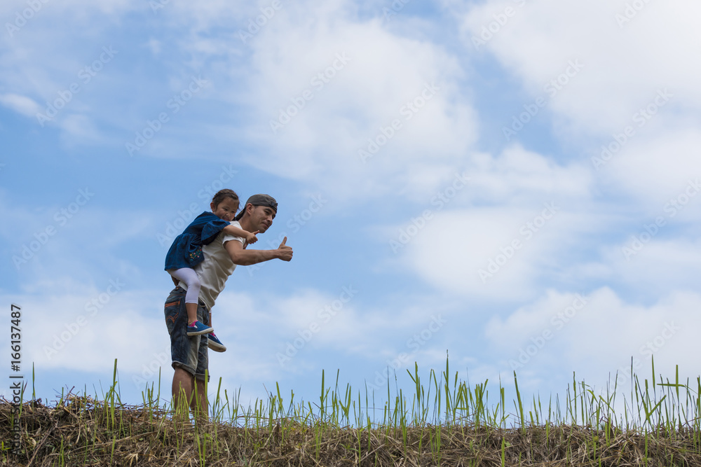 Father and daughter playing in the meadow Father and daughter playing in the meadow