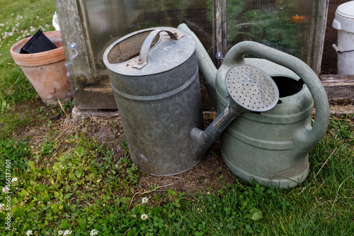 Used gardening equipment at the greenhouse: watering cans
