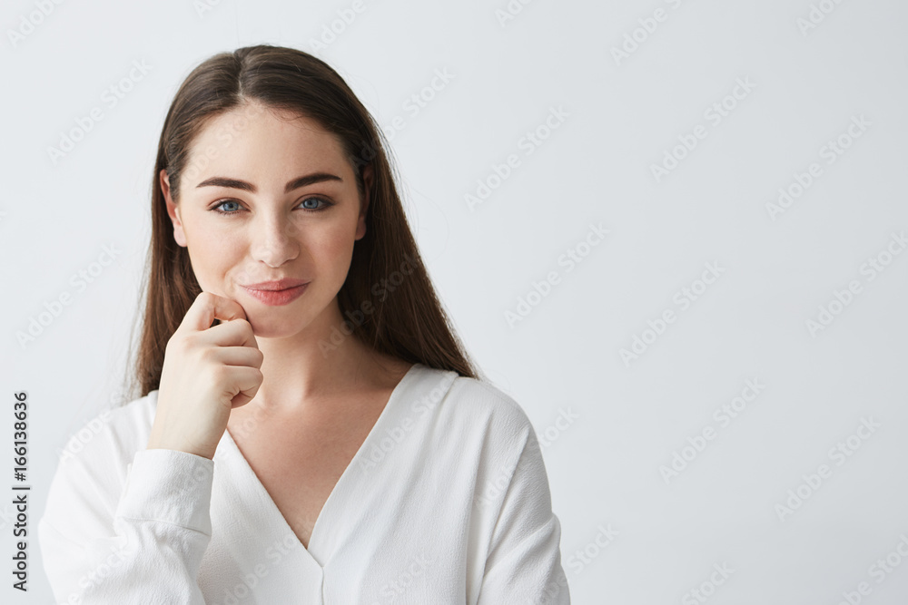 Young beautiful playful businesswoman with cunning tricky glance smiling looking at camera over white background. Young beautiful playful businesswoman with cunning tricky glance smiling looking at camera over white background.