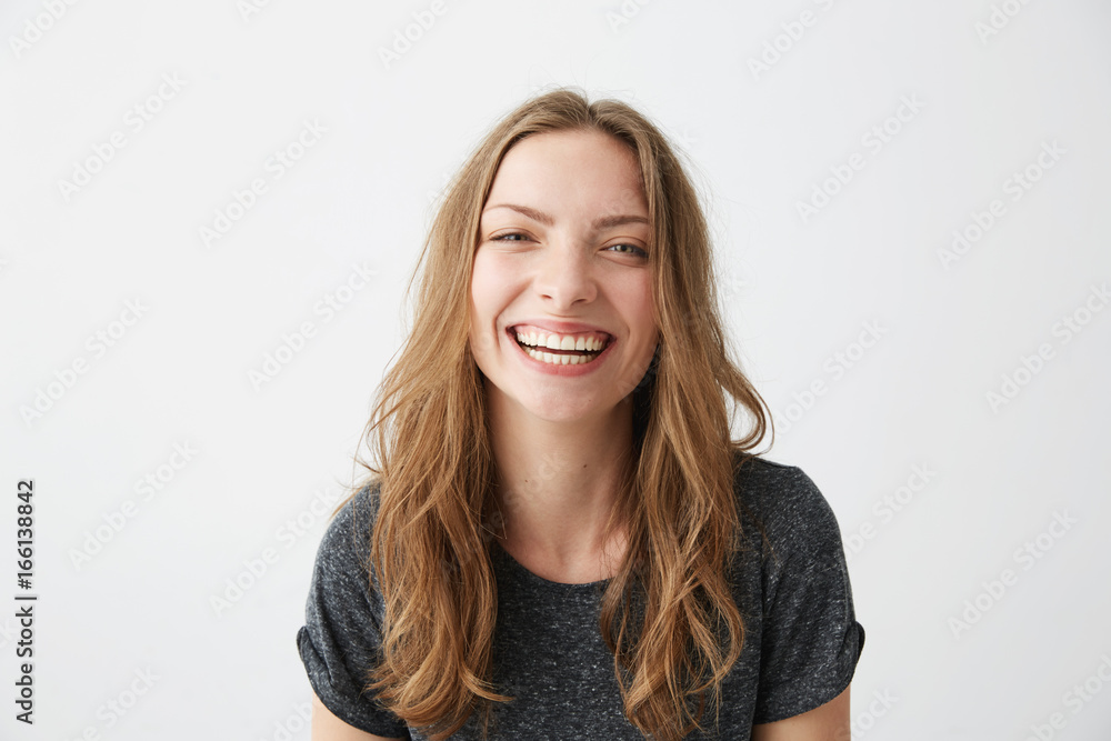 Young cheerful happy girl smiling laughing looking at camera over white background. Young cheerful happy girl smiling laughing looking at camera over white background.