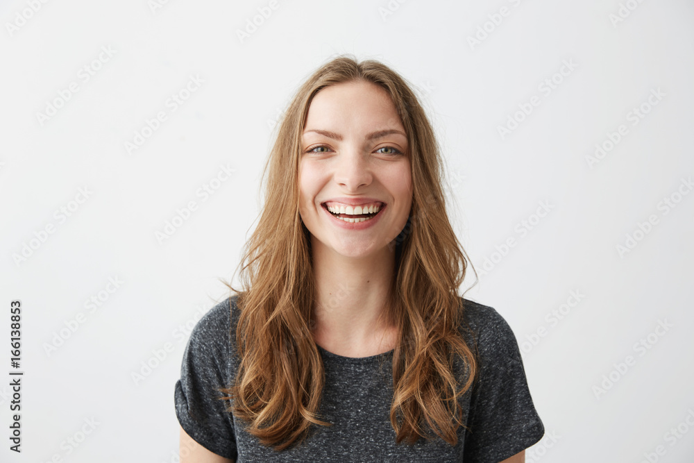 Young cheerful happy girl smiling laughing looking at camera over white background. Young cheerful happy girl smiling laughing looking at camera over white background.