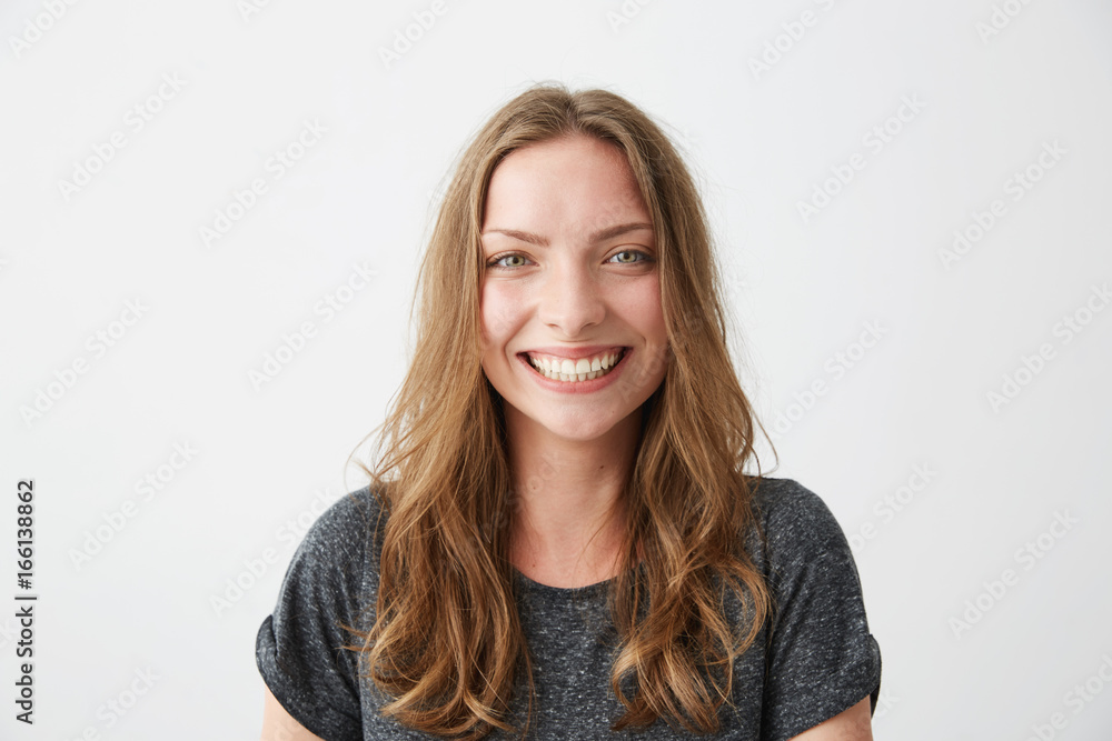 Young cheerful happy girl smiling laughing looking at camera over white background. Young cheerful happy girl smiling laughing looking at camera over white background.