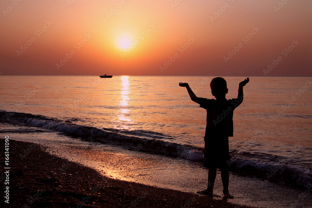 Little boy at sunrise