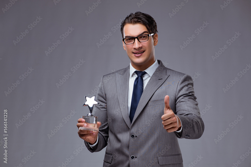 Businessman holding star award in business concept Businessman holding star award in business concept