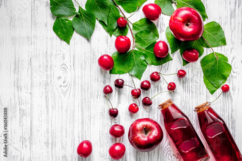 Summer fruit drink with apple, pulm and cherry on wooden table background top view copyspace
