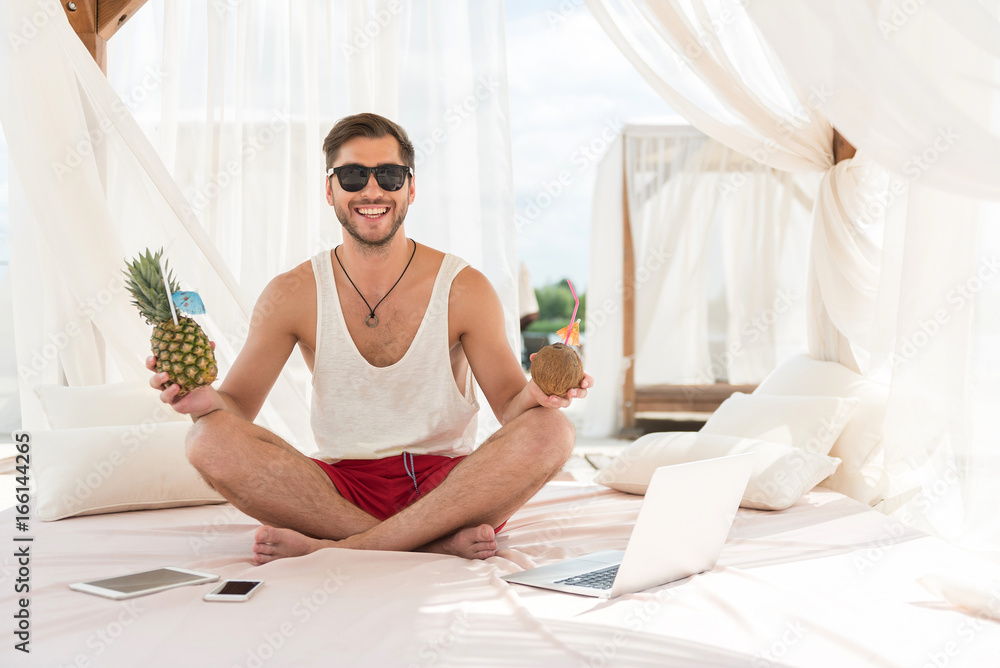 Jolly young bearded guy resting on summer resort Jolly young bearded guy resting on summer resort