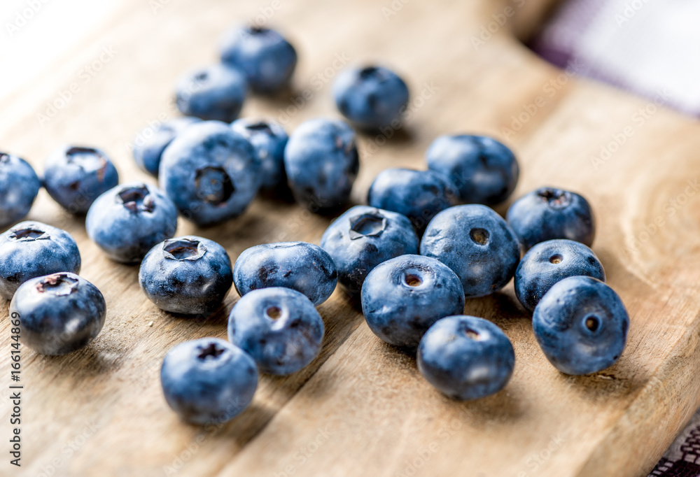 Freshly blueberries on wooden rustic wooden table. Juicy and fresh blueberries with green leaves. Bilberry on wooden background. Blueberry antioxidant. Concept for healthy eating and nutrition. Freshly blueberries on wooden rustic wooden table. Juicy and fresh blueberries with green leaves. Bilberry on wooden background. Blueberry antioxidant. Concept for healthy eating and nutrition.