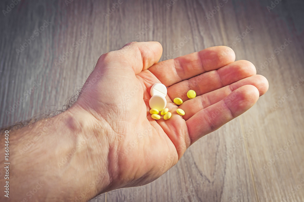 Pills in man's hand close-up. Health and medicine. Pharmaceuticals. Take pills, treatment. Pills in man's hand close-up. Health and medicine. Pharmaceuticals. Take pills, treatment.