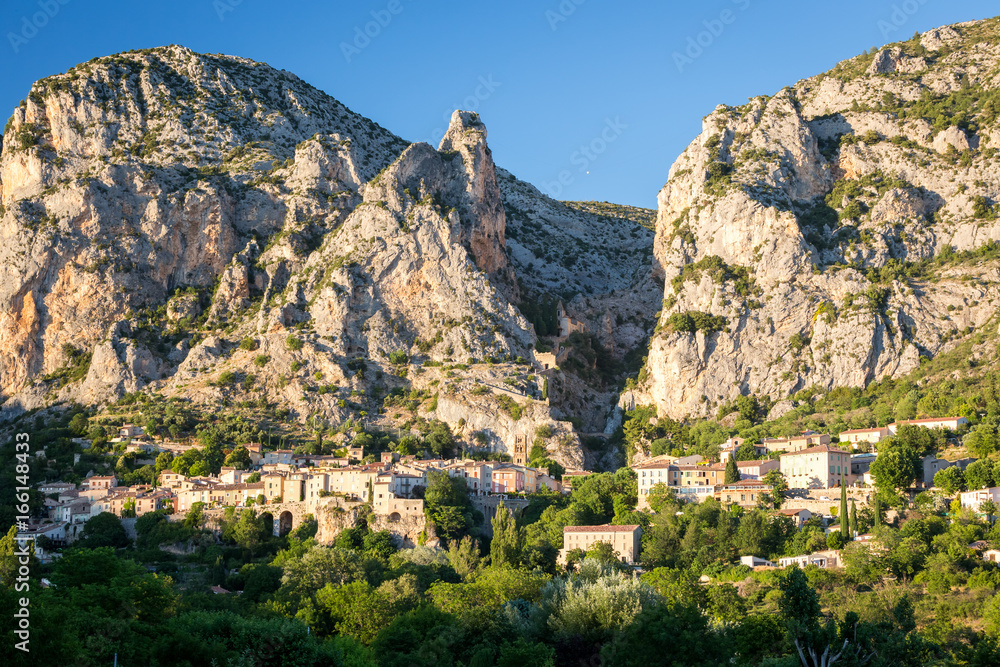 Fototapeta premium Charming village of Moustiers-Ste-Marie at sunset, Alpes-de-Haute-Provence, France