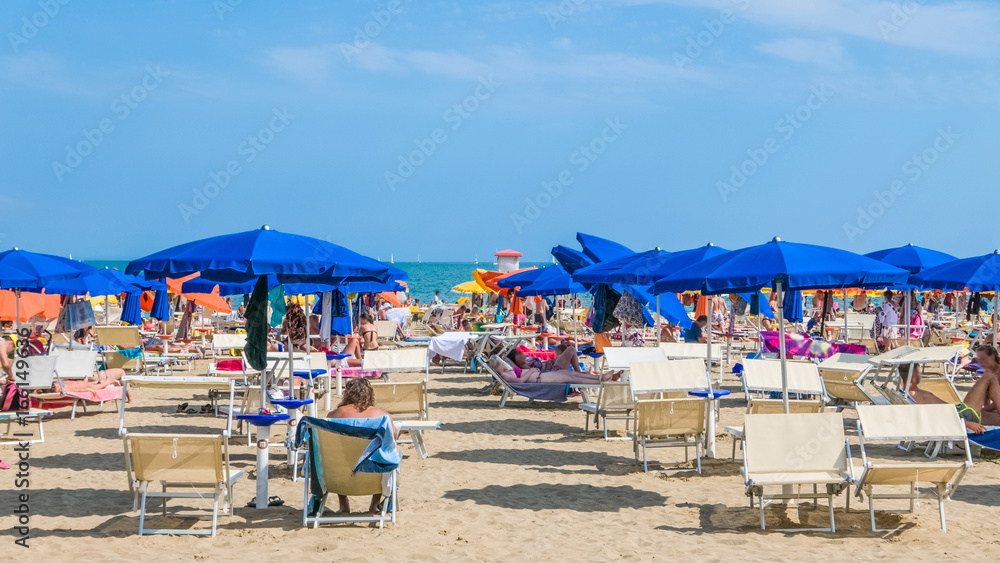 Blue umbrellas on the beach against the sea