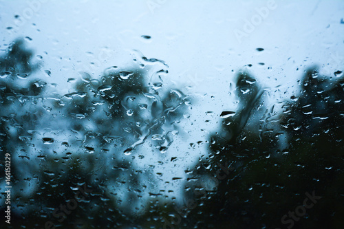Fotografie Rain on car windshield during a rainstorm on the road.