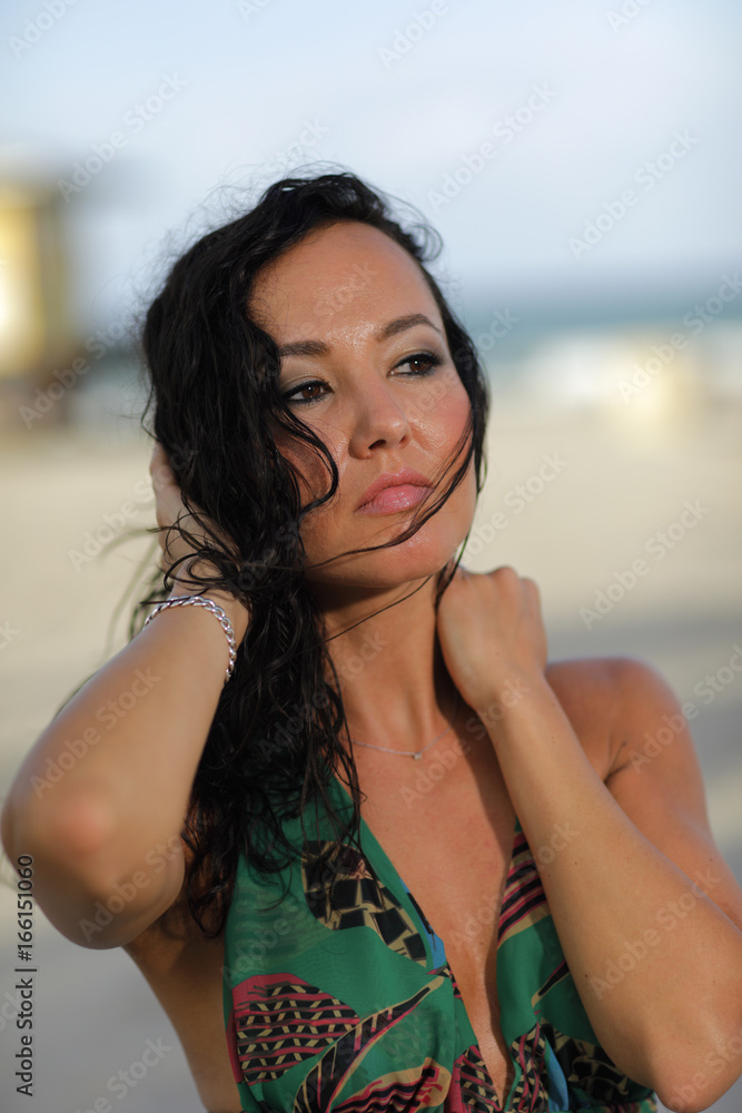 Fototapeta premium Attractive young brunette with hair blowing in her face