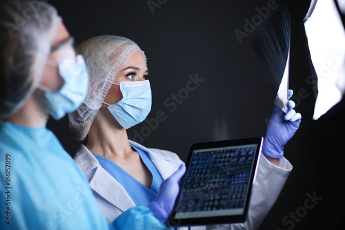 Medical team speaking of a X-ray in an operating room. Doctor. X-ray photo