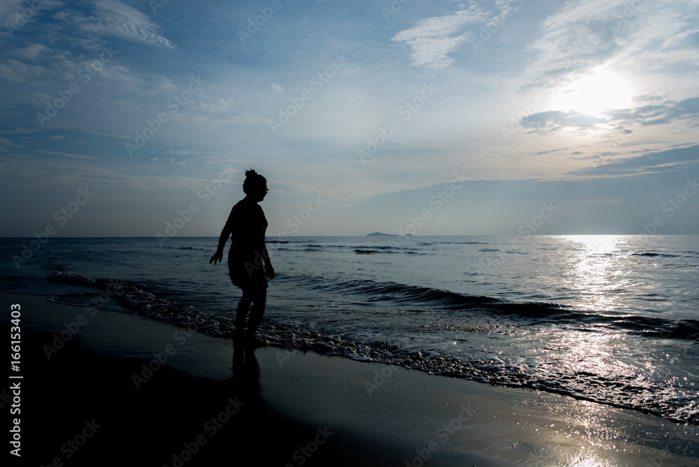 Womand with Tropical sunset on the beach Prachuap Khiri Khan. Thailand Womand with Tropical sunset on the beach Prachuap Khiri Khan. Thailand