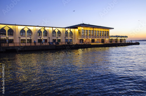 Photo of Kadıköy iskelesi (ferry terminal) at sunset time in IStanbul, Turkey