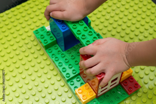 kid playing colorful toy blocks