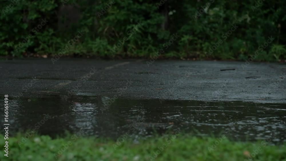 Closeup - Girl in Blue Rubber Boots Running Through the Puddles, Effectively Splashing Water Drops, Slowmotion Closeup - Girl in Blue Rubber Boots Running Through the Puddles, Effectively Splashing Water Drops, Slowmotion