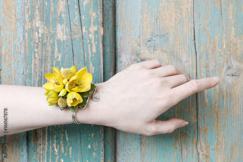 Canvas Print Wrist corsage made of yellow flowers.