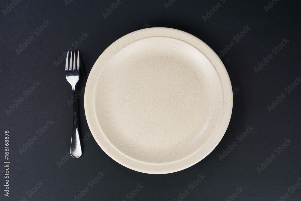 Plate  and fork  isolated on black background