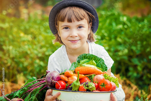 Child and vegetables. Selective focus.   photo