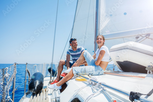 Father with adorable daughter resting on yacht