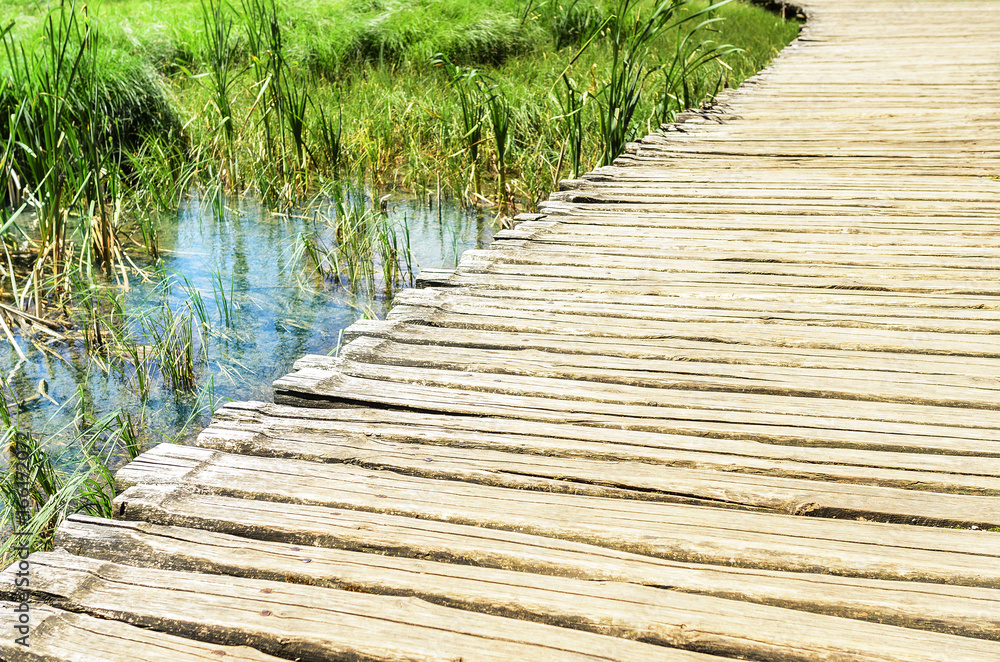 Fototapeta premium Wooden bridge over the water.