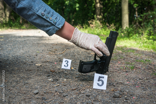 Investigator collects evidence - crime scene investigation