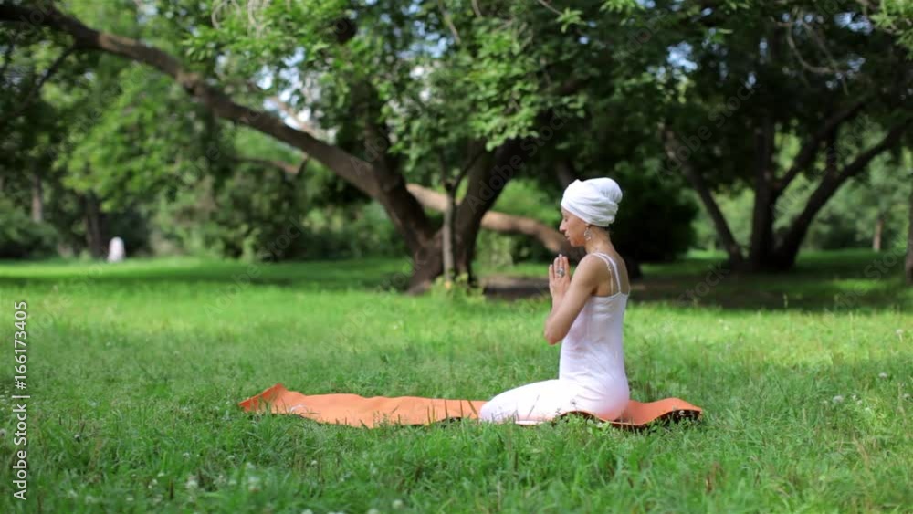 Woman Yoga Master Doing Yoga, Doing Asanas in the Park Woman Yoga Master Doing Yoga, Doing Asanas in the Park