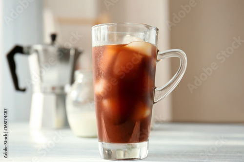 Glass cup with cold brew coffee on light background