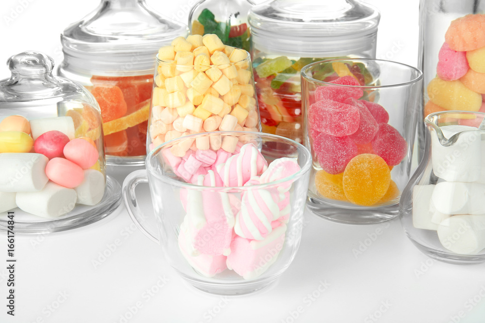 Colorful candies in glassware on white background, close up