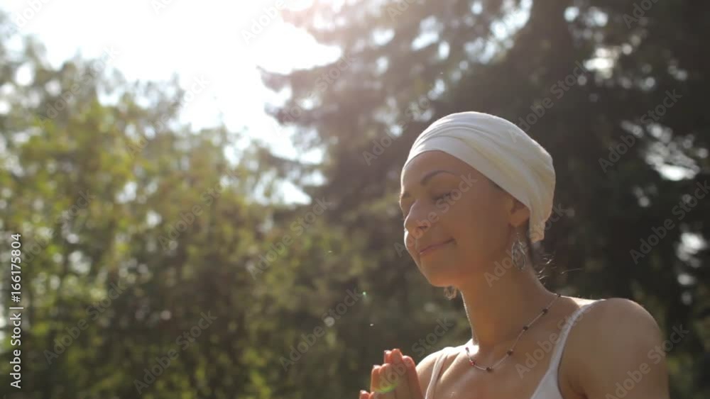 Woman Practicing Yoga in the Park at Sunset - Making Hand Greeting Namaste Woman Practicing Yoga in the Park at Sunset - Making Hand Greeting Namaste