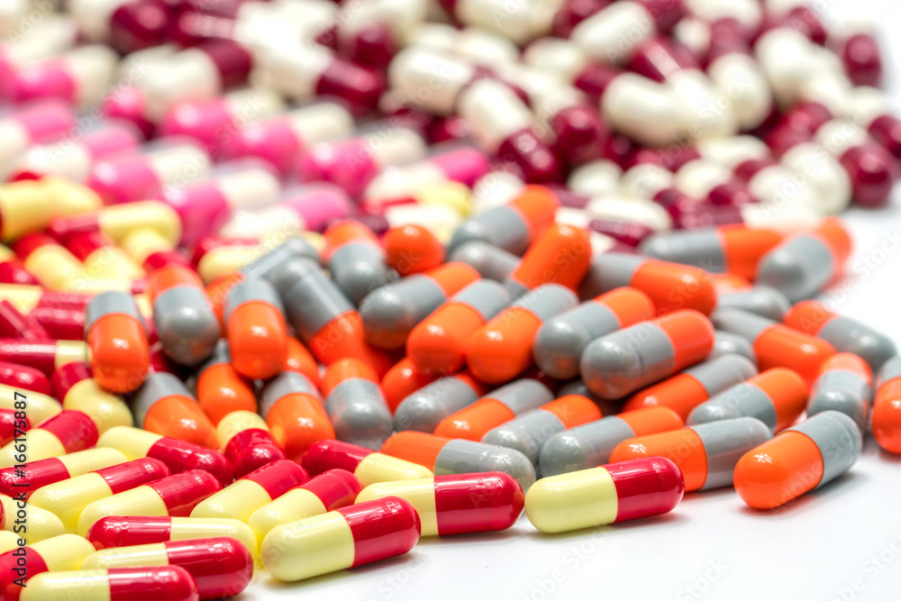 Colorful of antibiotic capsules pills on white background, drug resistance Colorful of antibiotic capsules pills on white background, drug resistance
