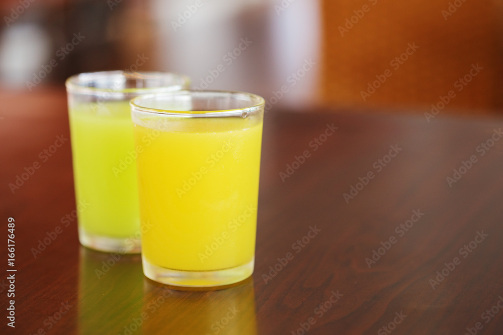 orange juice and guava juice on table orange juice and guava juice on table