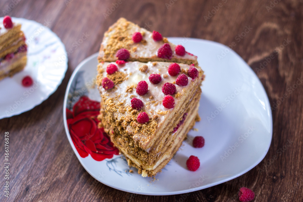 Homemade cake baking on a platter on a wooden background. Homemade cake baking on a platter on a wooden background.