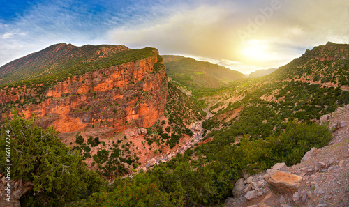 look on bright, saturated color of the mountain of the Atlas on a sunset in Morocco, on a slope of mountains winds the road