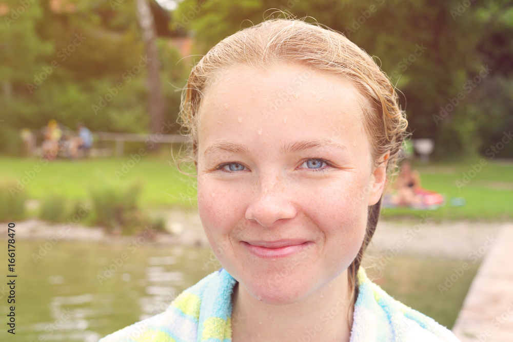 Young woman at a lake after a morning swimming Young woman at a lake after a morning swimming