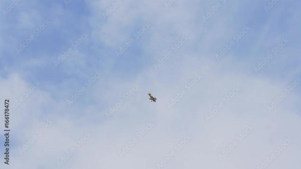 Sports plane makes aerobatics in the blue sky.Sport airplane. Flying in the sky, 4k. Sports plane makes aerobatics in the blue sky.Sport airplane. Flying in the sky, 4k.